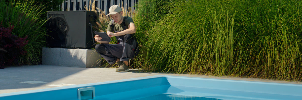 Technicien qualifié réalisant un diagnostic à proximité de la piscine